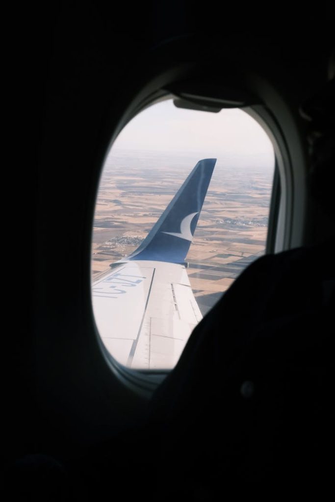Scenic view of an airplane wing over Diyarbakır seen through the window.
